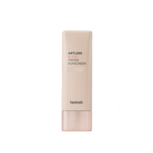 Load image into Gallery viewer, HEIMISH Artless Glow Tinted Sunscreen Shine Beige delivers a natural, radiant finish while providing a hint of coverage to even out skin tone. Infused with pearl extract and botanical ingredients like rosa canina fruit and thyme leaf extracts, it nourishes and revitalizes the skin. The lightweight formula blends effortlessly, leaving a dewy, glowing finish without feeling heavy or sticky. Enhanced with niacinamide and adenosine, it helps brighten and support skin elasticity, making it a perfect choice for a